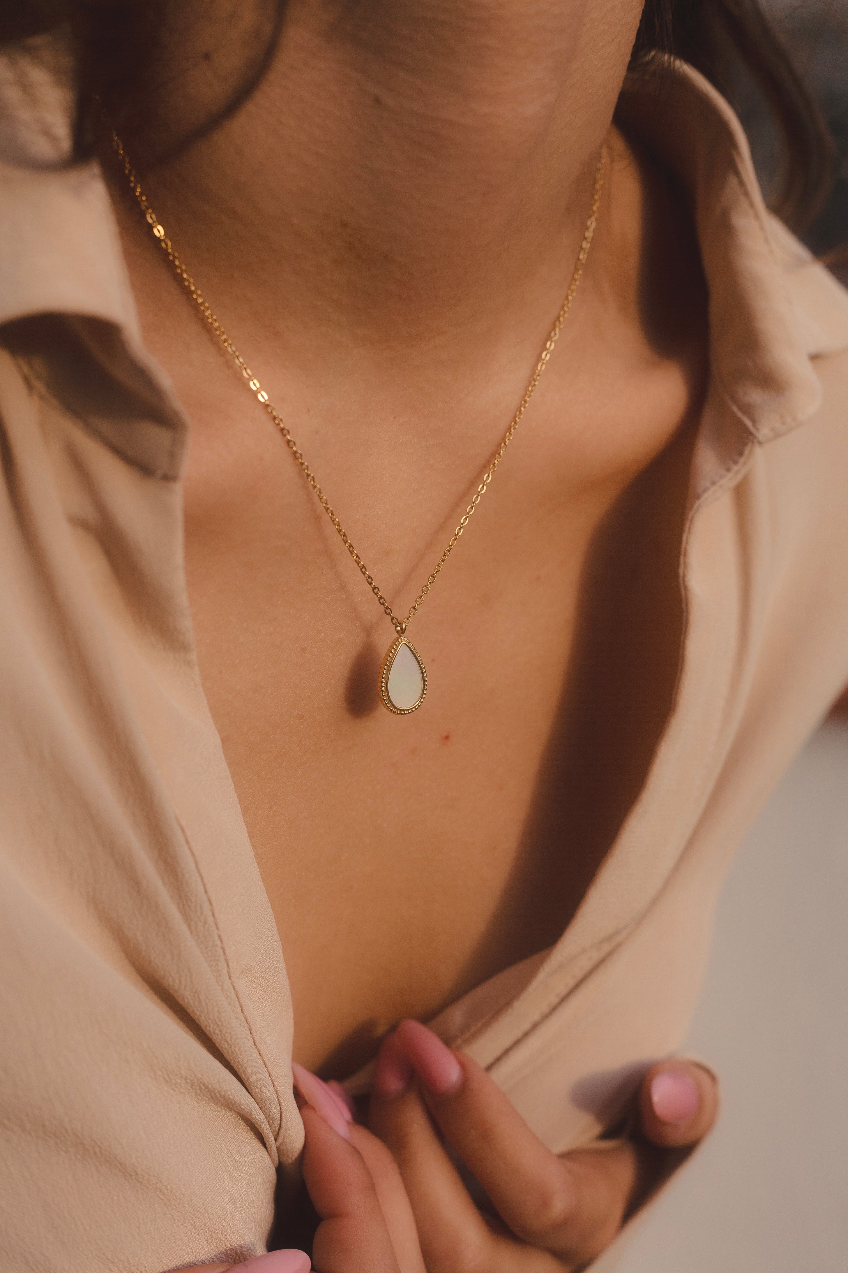Collar dorado con colgante en forma de lágrima de nácar